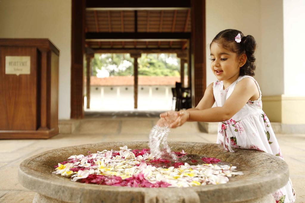 Heritage Maduraj Zewnętrze zdjęcie A girl playing with flowers
